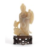Good Chinese agate carving of a girl holding a vase raised on a carved hardwood stand, overall 18.