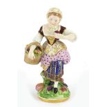 19th century Chelsea hand painted figurine of a girl holding a basket of flowers, anchor mark to the