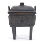 Chinese archaic style bronze censer and cover with twin handles, cast in relief with mythical faces,