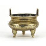 Chinese bronze tripod censer with twin handles, engraved with figures, character marks to the