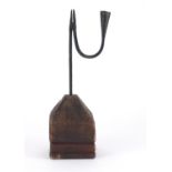 18th century steel rush light holder raised on a woodblock base, overall 32.5cm high :For Further