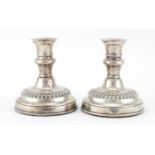 Pair of silver dwarf candlesticks with ebony bases, by J Sherwood & Sons, 11cm high, 498.6g :For