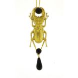 Egyptian Revival brass and black agate stag beetle pendant on necklace, the pendant 9cm in length :
