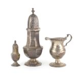 Two octagonal silver baluster shaped casters and a pedestal milk jug, various hallmarks, the largest
