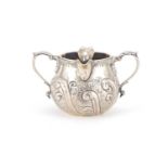 Victorian silver twin handled cream jug with two spouts and embossed with foliage, J C London
