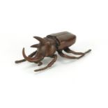 Japanese bronze beetle with articulated wings, impressed marks to the underside, 11cm in length :For