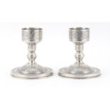 Pair of Persian silver candlesticks with engraved decoration, impressed marks to the base, 11cm
