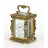 Miniature brass cased carriage clock by Charles Frodsham, with nude female supports, the enamelled