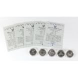 Five United States of America silver dollars, with certificates including Mount Rushmore, National