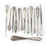 Collection of Victorian and later silver handled button hooks, some embossed with putti, various