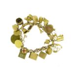 9ct gold charm bracelet with a large selection of mostly gold charms including London Bridge, Eiffel