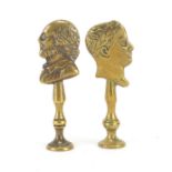 Two Victorian brass pipe tamper's in the form of two busts including Charles Dickens, the largest