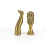 Two Victorian brass pipe tamper's in the form of a leg and bearded gentleman bust, the largest 4.5cm