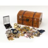 Costume jewellery housed in a dome top atlas box including a silver mother of pearl pendant,