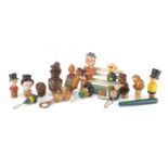 Collection of mostly carved black forest corkscrews and bottle openers with a bench design rack, the
