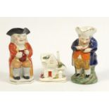 Two Staffordshire Toby jugs and a pastille burner, the largest 24cm high : For Further Condition