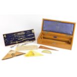 A G Thornton light oak cased set of drawing apparatus, some with ivory handles, 37cm in length : For