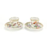 Two Dresden porcelain cups and saucers hand painted and gilded with flowers, the saucers, 13cm in