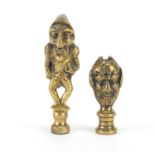 Two Victorian brass pipe tamper's in the form of a comical soldier and devil bust, the largest 6.5cm