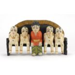 Set of five Chinese carved wood figures, seated on a bench, 41cm in length : For Further Condition