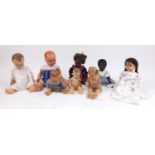 Eight vintage composite dolls, some with articulated limbs and open/close eyes, the largest 62cm