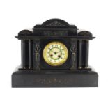 Victorian black slate mantel clock with architectural columns, the enamelled chapter ring with