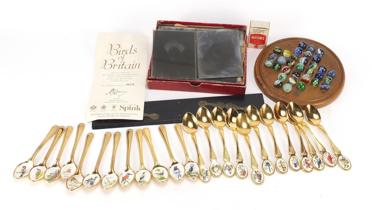 Objects including birds of Britain collectors spoons, Victorian solitaire board with glass marbles