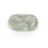 Chinese celadon glazed scroll weight, decorated in relief with two fish, character marks to the