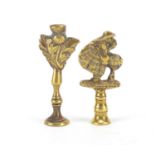 Two Victorian brass pipe tamper's in the form of a girl in a crinoline dress and a Scottish thistle,