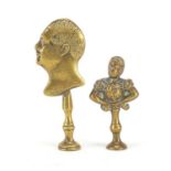 Two Victorian brass pipe tamper's in the form of two classical busts, the largest 7.5cm high : For