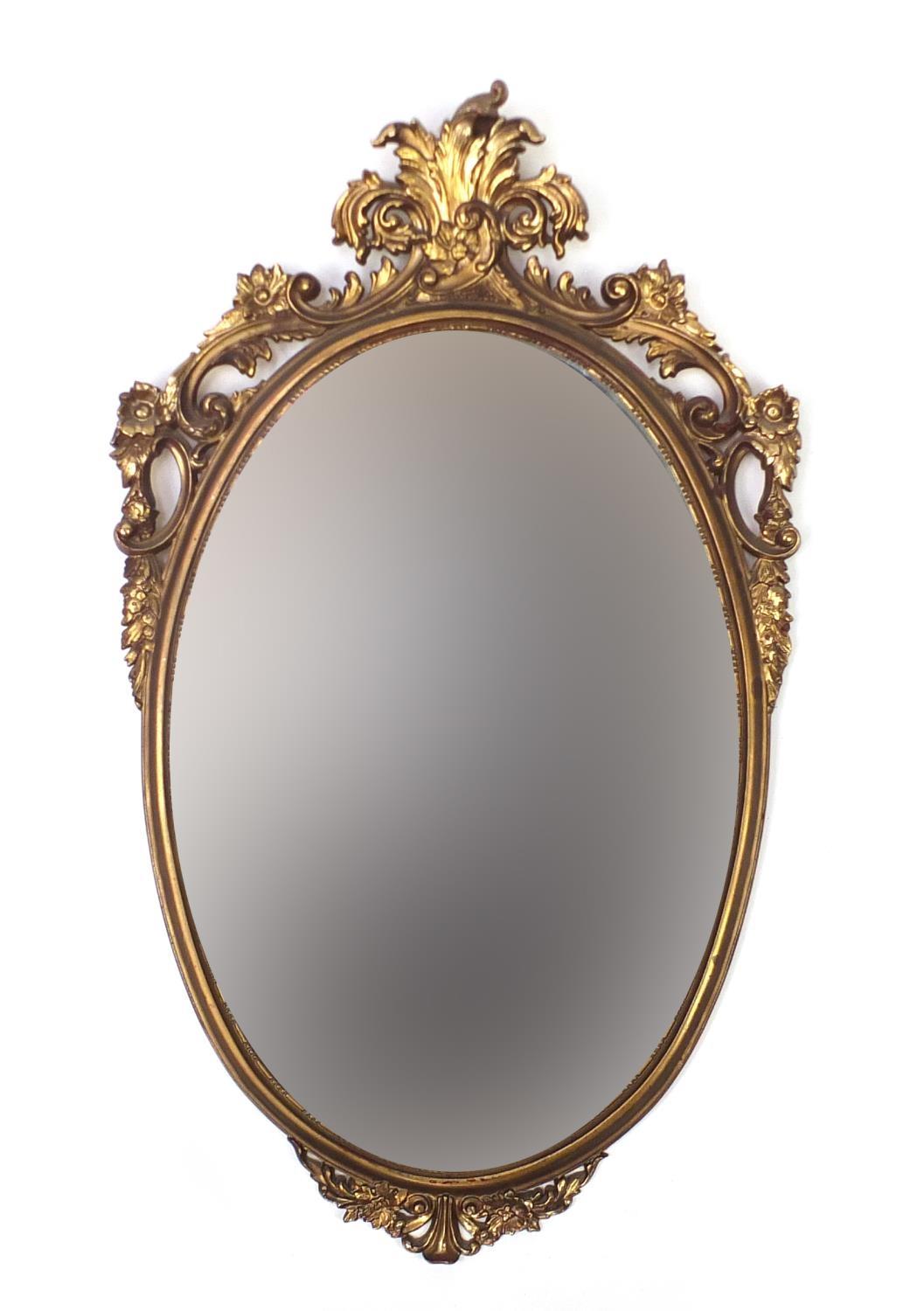 Oval gilt framed wall hanging mirror, 83cm x 51cm : For Further Condition Reports Please visit our