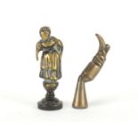 Two Victorian brass pipe tamper's in the form of a Victorian maid and a leg with boot, the largest