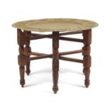 Indian brass tray topped folding table, 46cm high x 56cm in diameter : For Further Condition Reports