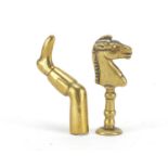 Two Victorian brass pipe tamper's in the form of a horse and leg with boot, the largest 5.5cm high :