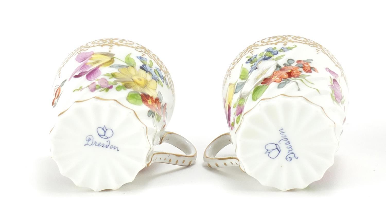 Two Dresden porcelain cups and saucers hand painted and gilded with flowers, the saucers, 13cm in - Image 3 of 5