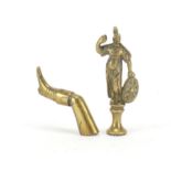 Two Victorian brass pipe tamper's in the form of a Roman Gladiator and leg with boot, the largest
