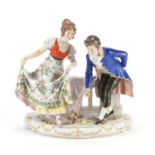 Continental porcelain figure group of a courting couple, painted marks to the base, 22cm high :