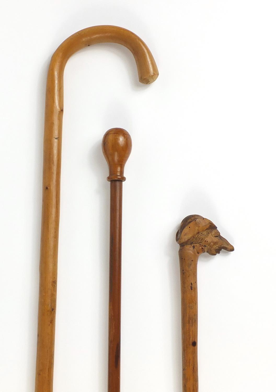 Three wooden walking canes one with carved head handle : For Further Condition Reports Please - Image 2 of 5