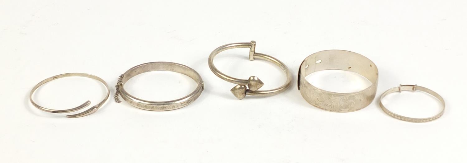 Five silver and white metal bangles, 65.5g : For Further Condition Reports Please visit our