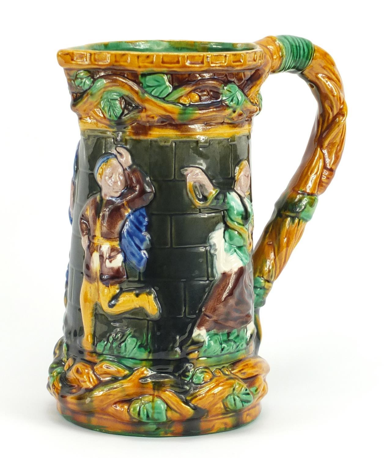 Large Majolica jug, relief decorated with dancing figures, 24.5cm high : For Further Condition