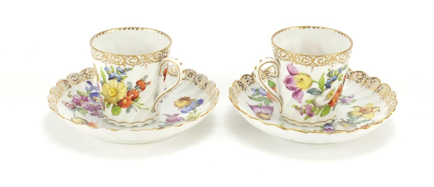 Two Dresden porcelain cups and saucers hand painted and gilded with flowers, the saucers, 13cm in - Image 2 of 5