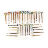 Group of light and dark wood sewing bobbins with glass beads : For Further Condition Reports