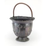 Art Nouveau copper bucket with swing handle, embossed with stylised motifs, 32cm high excluding