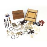 Costume jewellery including brooches, wristwatches and necklaces, housed in two leather jewellery