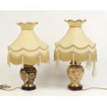 Two Chinese porcelain table lamps with shades, the bases decorated with butterflies amongst flowers,