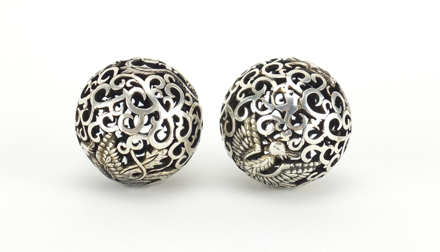 Pair of Chinese silver coloured metal stress balls, pierced with dragons and phoenixes, each 4.5cm - Image 2 of 4