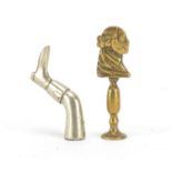 Two Victorian brass pipe tamper's in the form of a classical bust and leg with boot, the largest 6cm