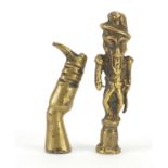 Two Victorian brass pipe tamper's in the form of a comical soldier and a leg with boot, the