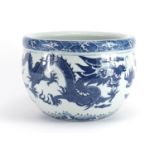 Chinese blue and white porcelain jardinière decorated with dragons amongst clouds chasing the