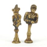 Two Victorian brass pipe tamper's in the form of a jockey and African figure, the largest 5.5cm high